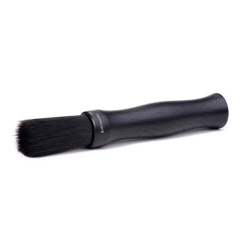 Normcore Barista Brush with black oak handle removing coffee grounds