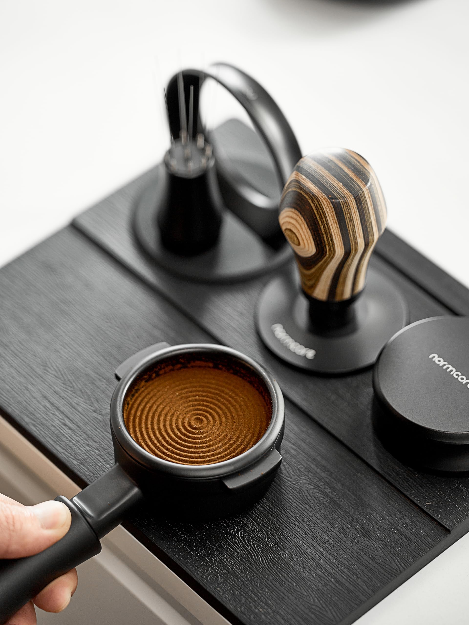 Normcore tamping mat side profile highlighting built-in tamp stand for quick access.