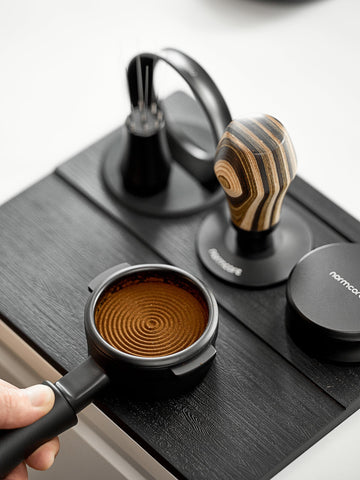 Normcore tamping mat side profile highlighting built-in tamp stand for quick access.
