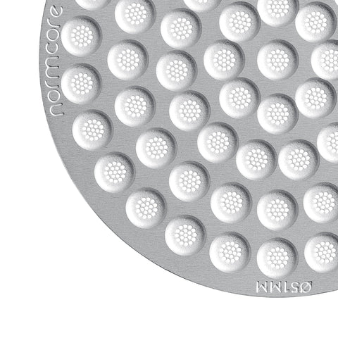 Normcore puck screen in use over the brew head for easier maintenance