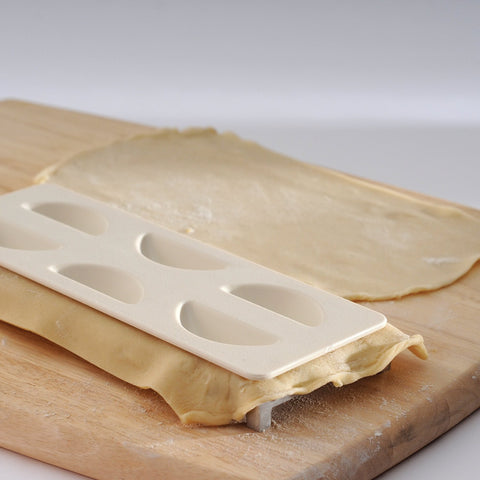 Norpro pierogi maker fill-seal guides dough over filling neatly.