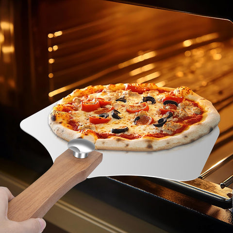 Nsoyos pizza peel extended handle demonstrates full reach for plating.