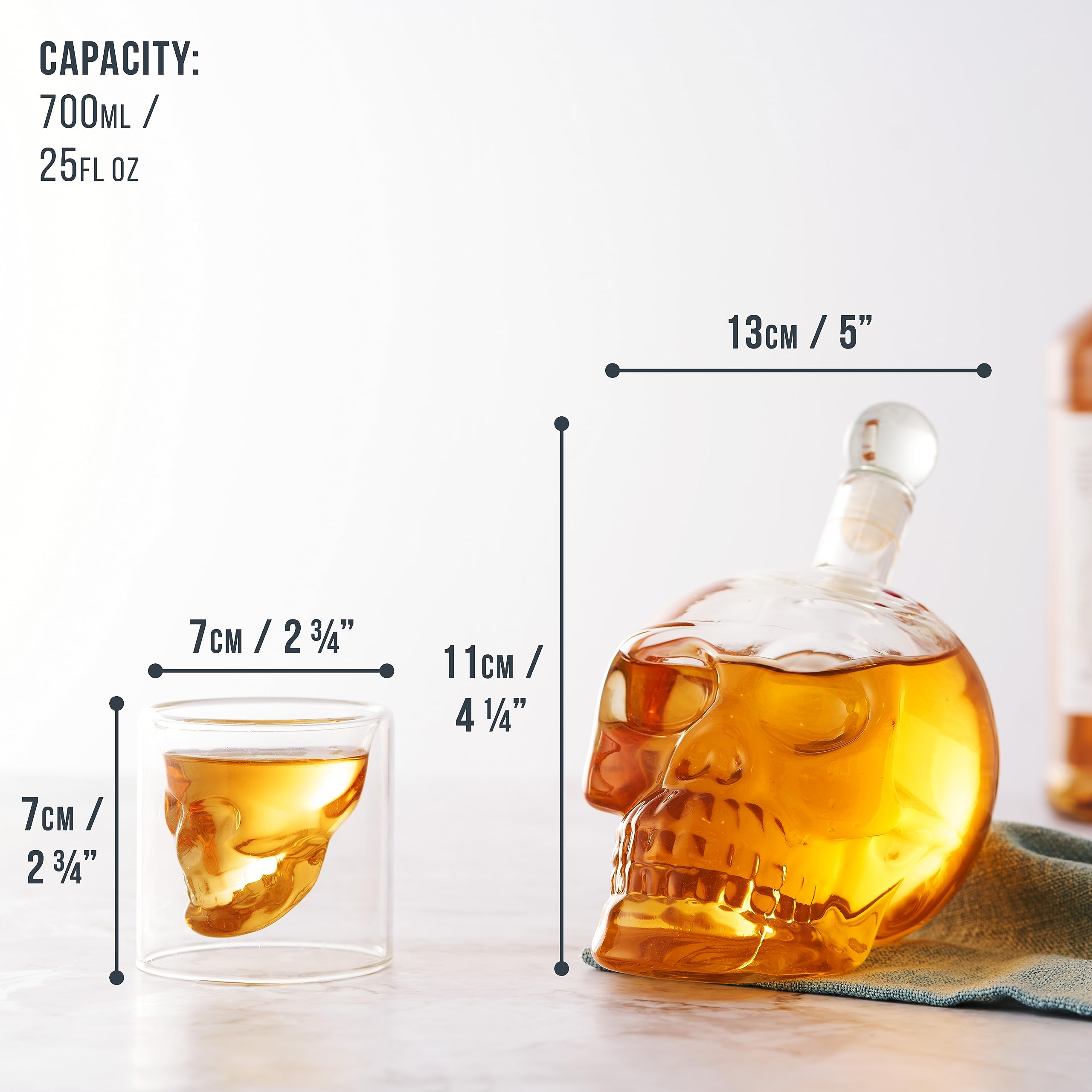 Skull decanter with lid in a contemporary bar setup.
