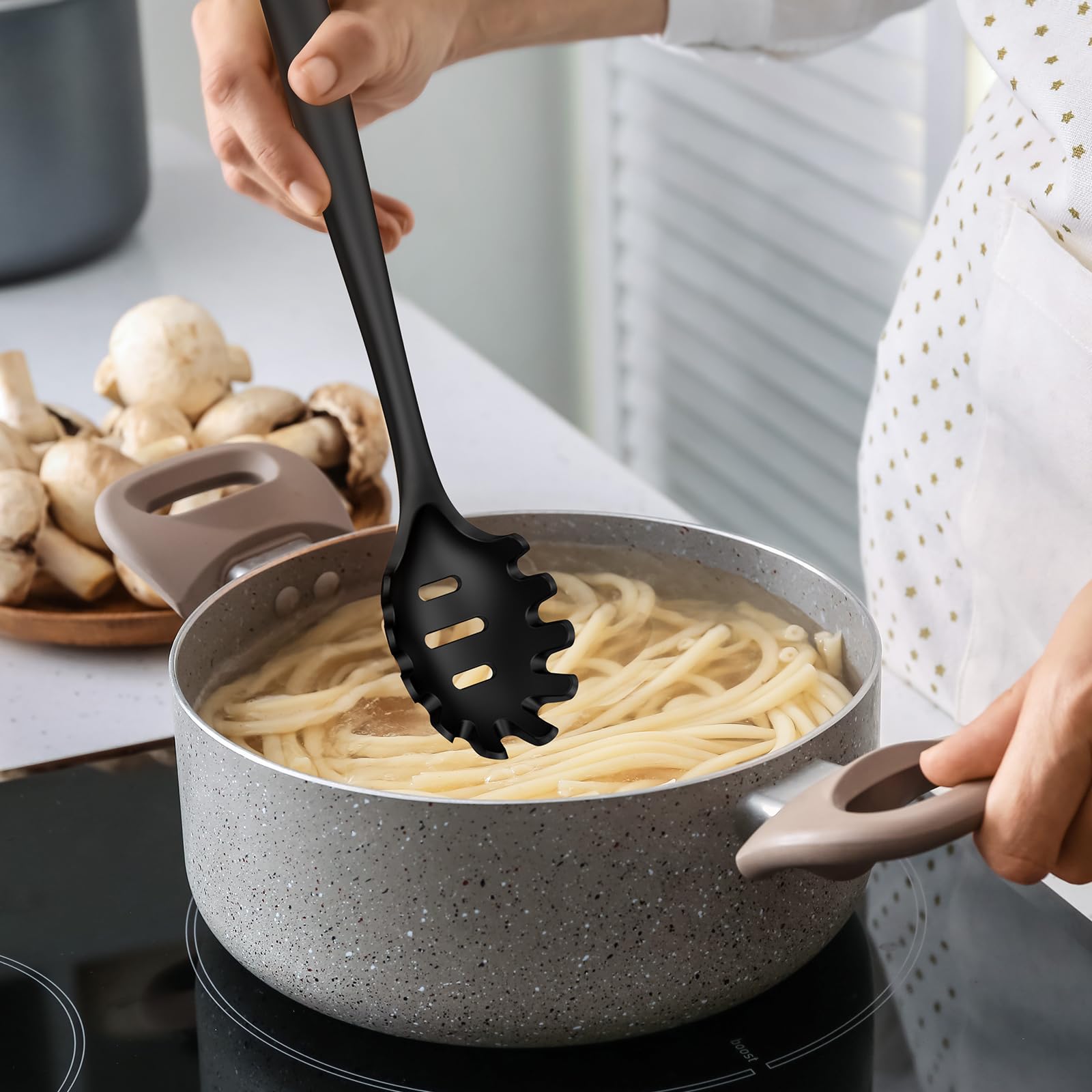 Oannao turner flips pancakes on a nonstick skillet.