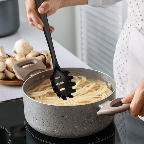 Oannao turner flips pancakes on a nonstick skillet.