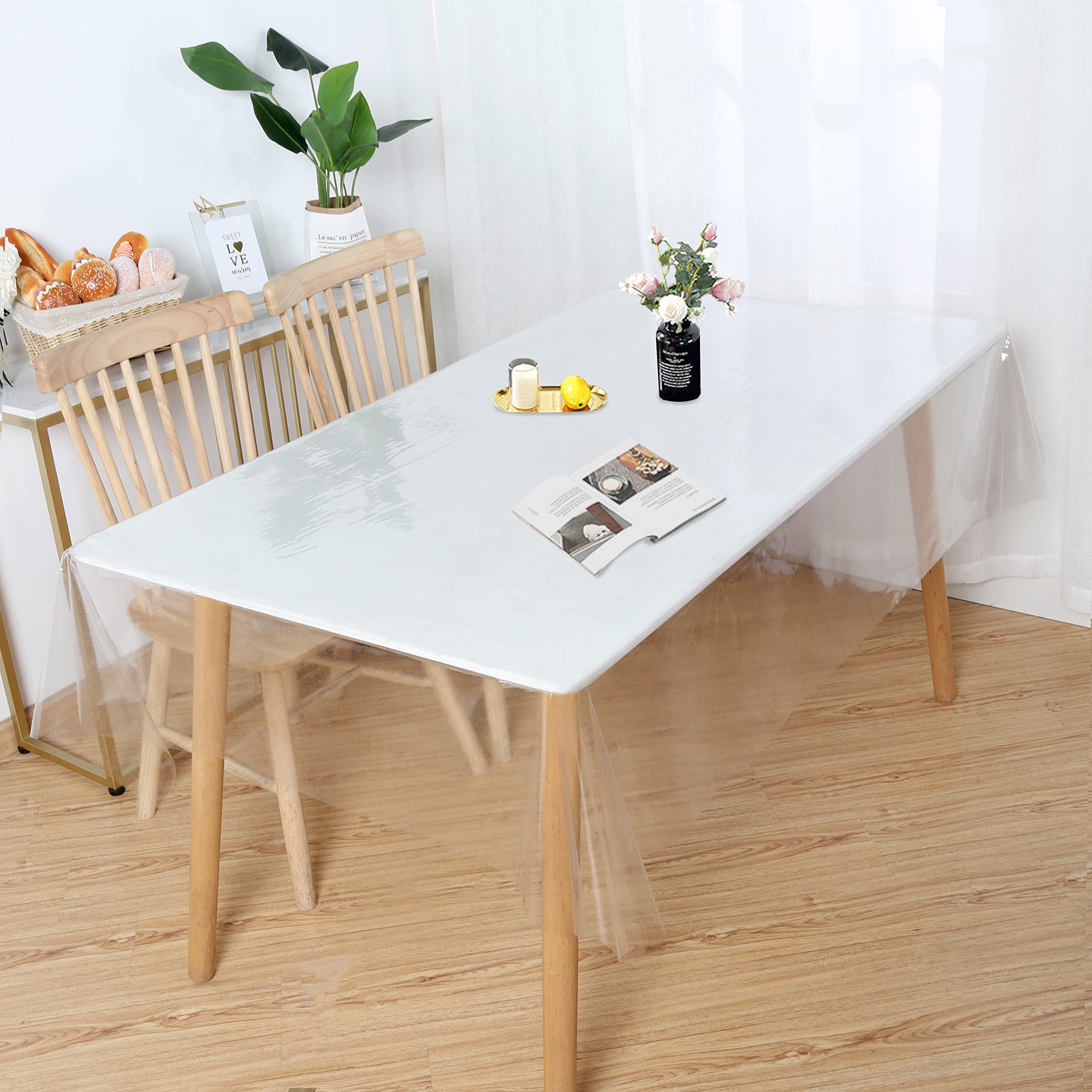 Obstal clear tablecloth rectangle table protector used in cafe or event setting.