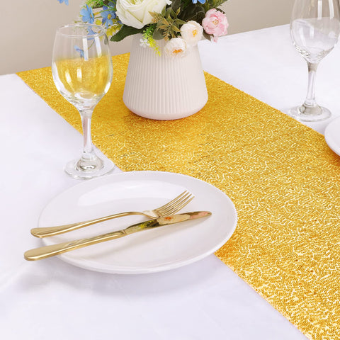 OGORI gold sequin table runner decorates wedding reception tables.
