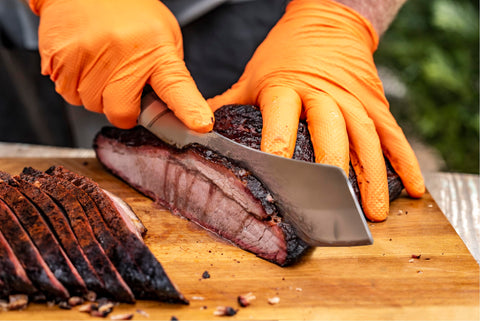 Oklahoma Joe's Blacksmith cleaver chopping vegetables with precision