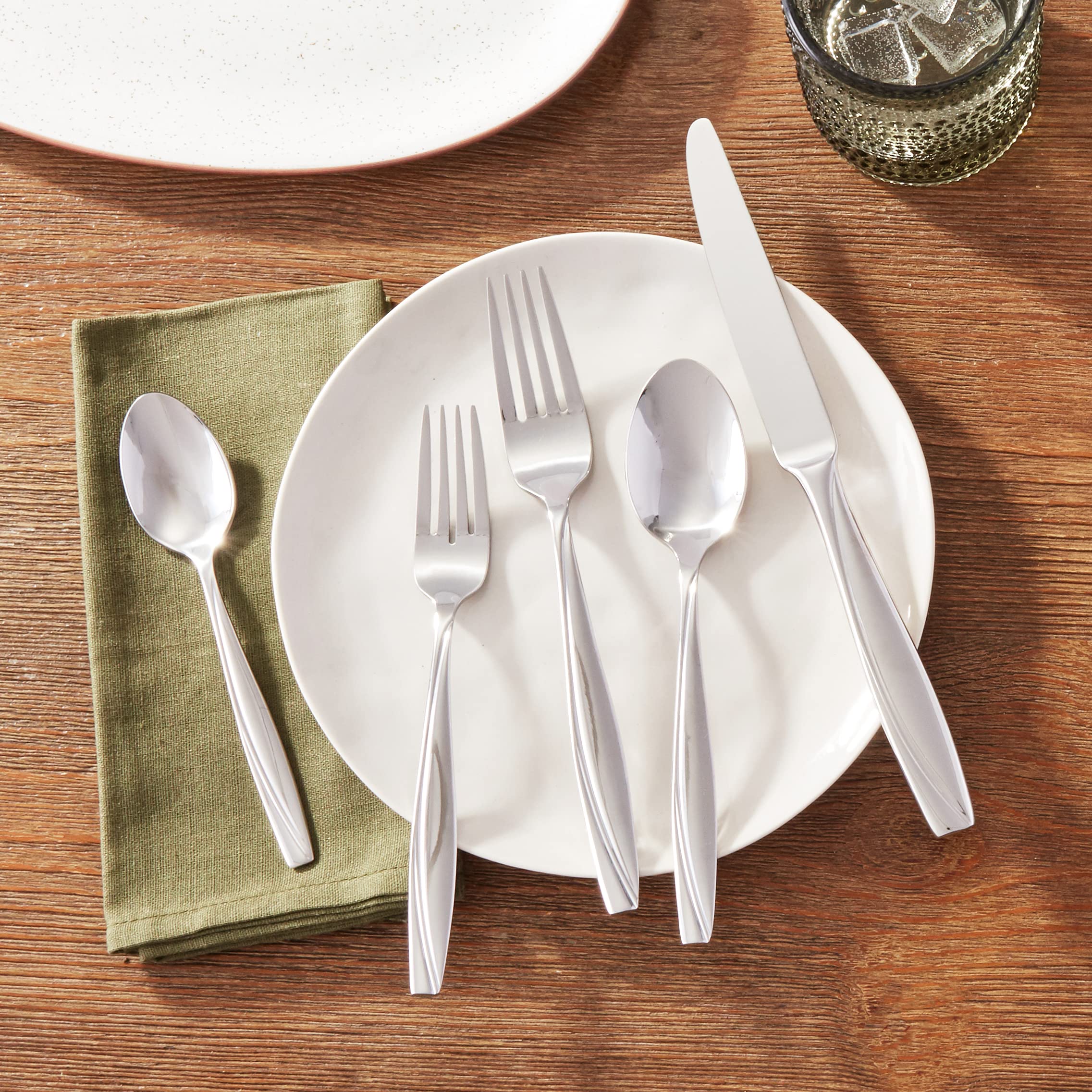 Oneida Camlynn Mirror swoop-handle creates a striking visual contrast.