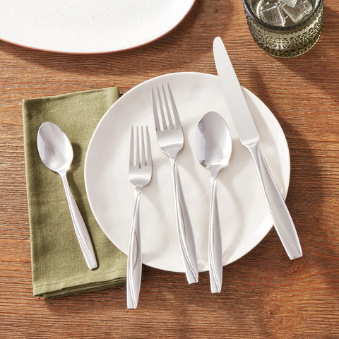 Oneida Camlynn Mirror swoop-handle creates a striking visual contrast.