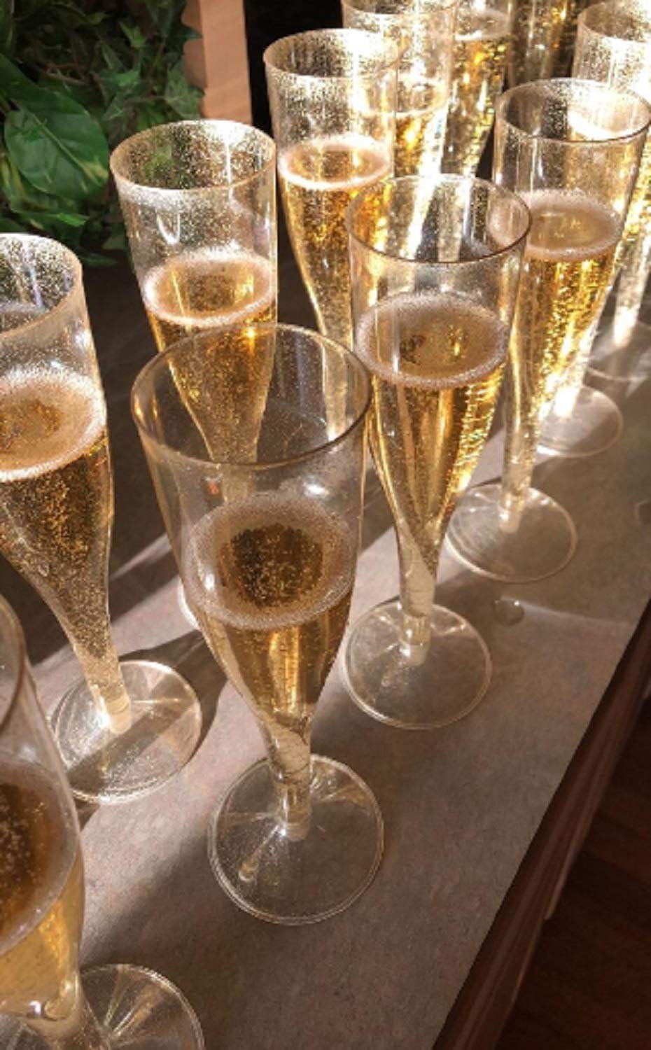 Oojami gold glitter detail adds festive shine to party champagne flutes.