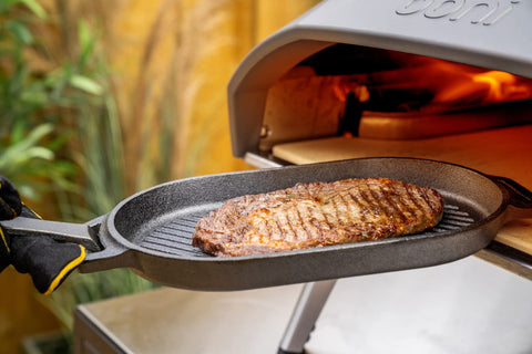 Ooni Grizzler Pan over open flame delivering authentic sear marks.