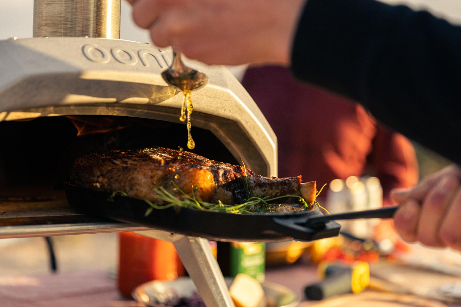 Ooni Cast Iron Sizzler Pan sear-ready design enhances steak and vegetables.