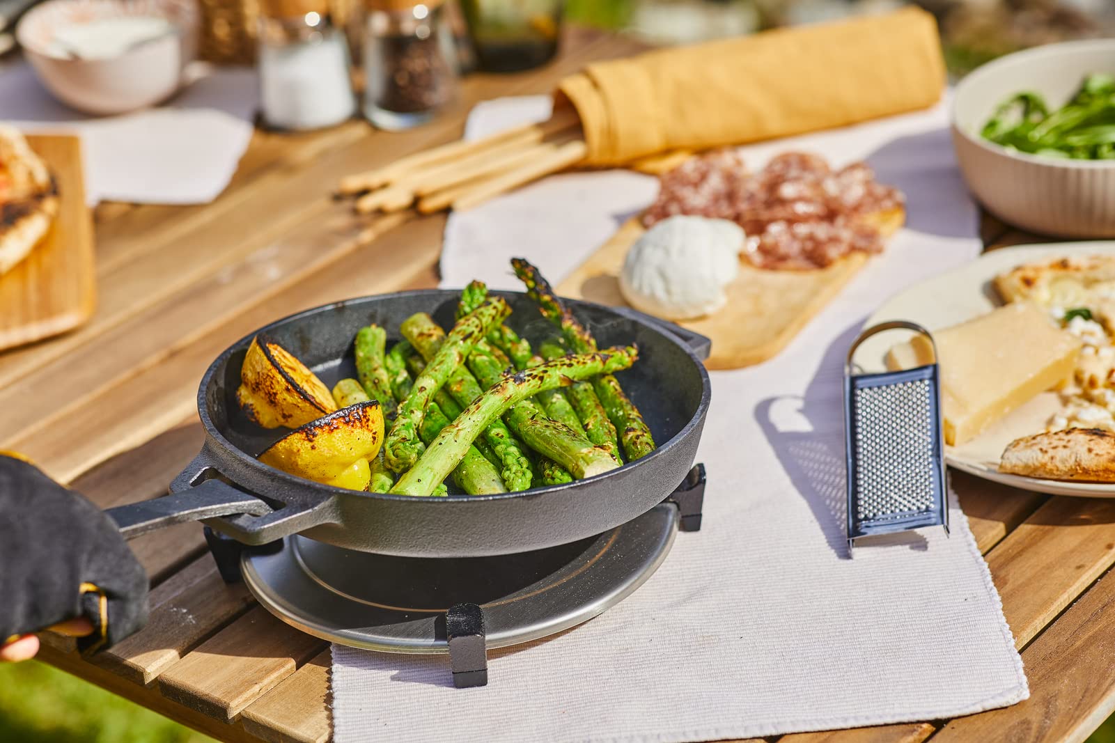Ooni Cast Iron Skillet in a pizza oven setup for finishing crusts.