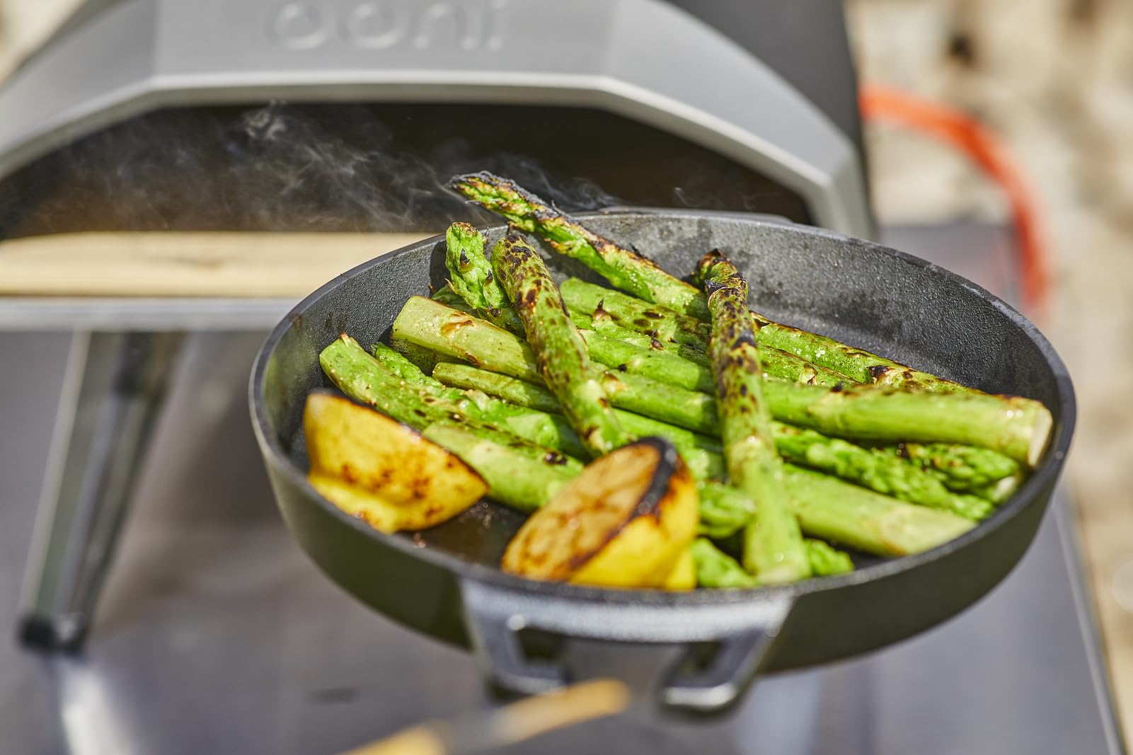 Ooni skillet searing meat to develop a rich crust and flavor.