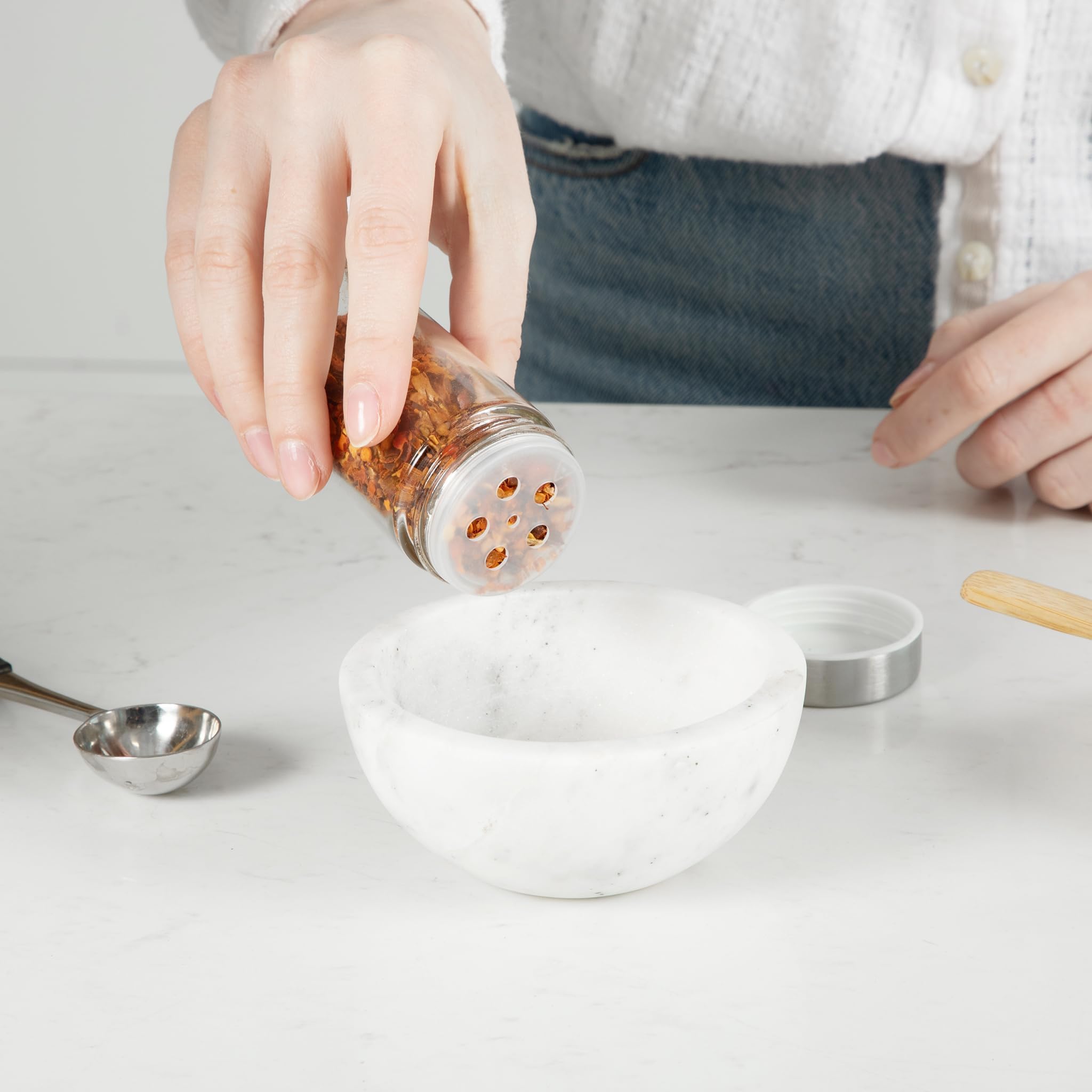 Orii rotating spice tower on counter helps busy cooks access jars.