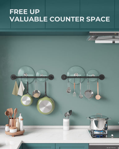 OROPY pots and pans neatly hung on wall rack demonstrating space saving.