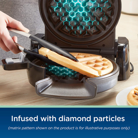 Oster measuring cup with batter demonstrates precise pour for waffles.