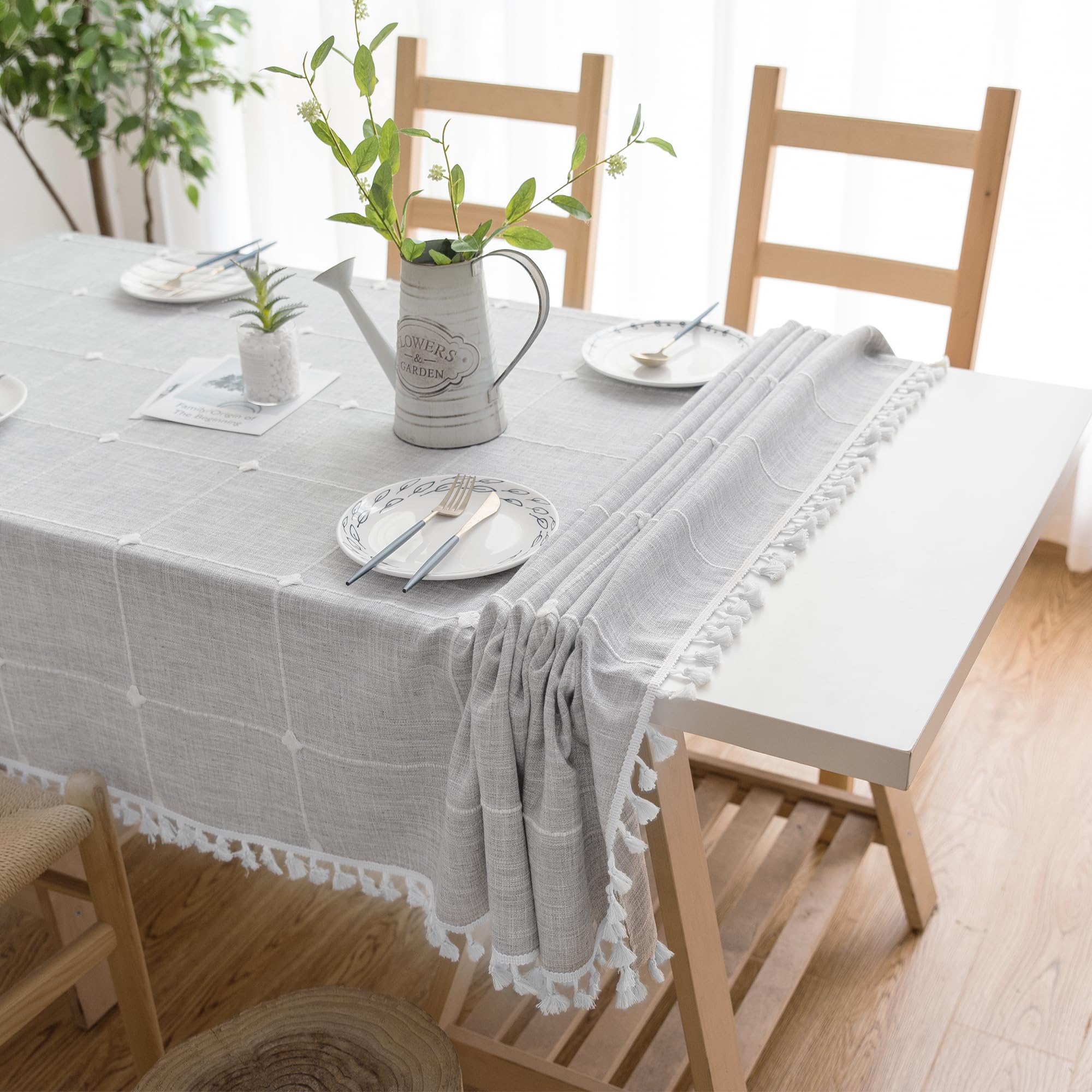 Oubonun 55x70 tablecloth draped on a dining table for four to six seats.