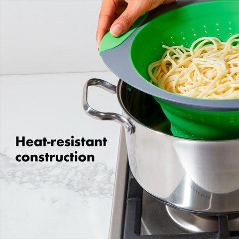 OXO collapsible colander folded for nesting in small cabinets.