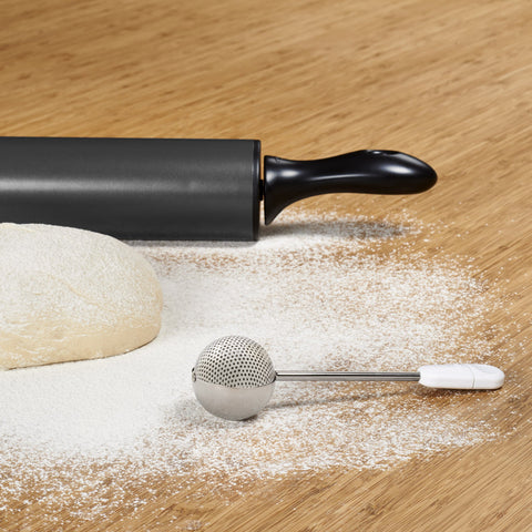 OXO Good Grips Baker's Dusting Wand evenly dusting flour on surfaces
