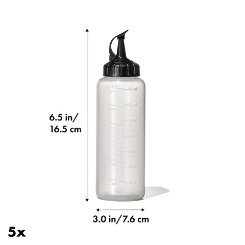 Attached cap remains open for one-handed pouring and quick shaking with OXO bottle.