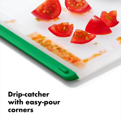 OXO Good Grips cutting board features integrated drip-catcher to keep juices contained.