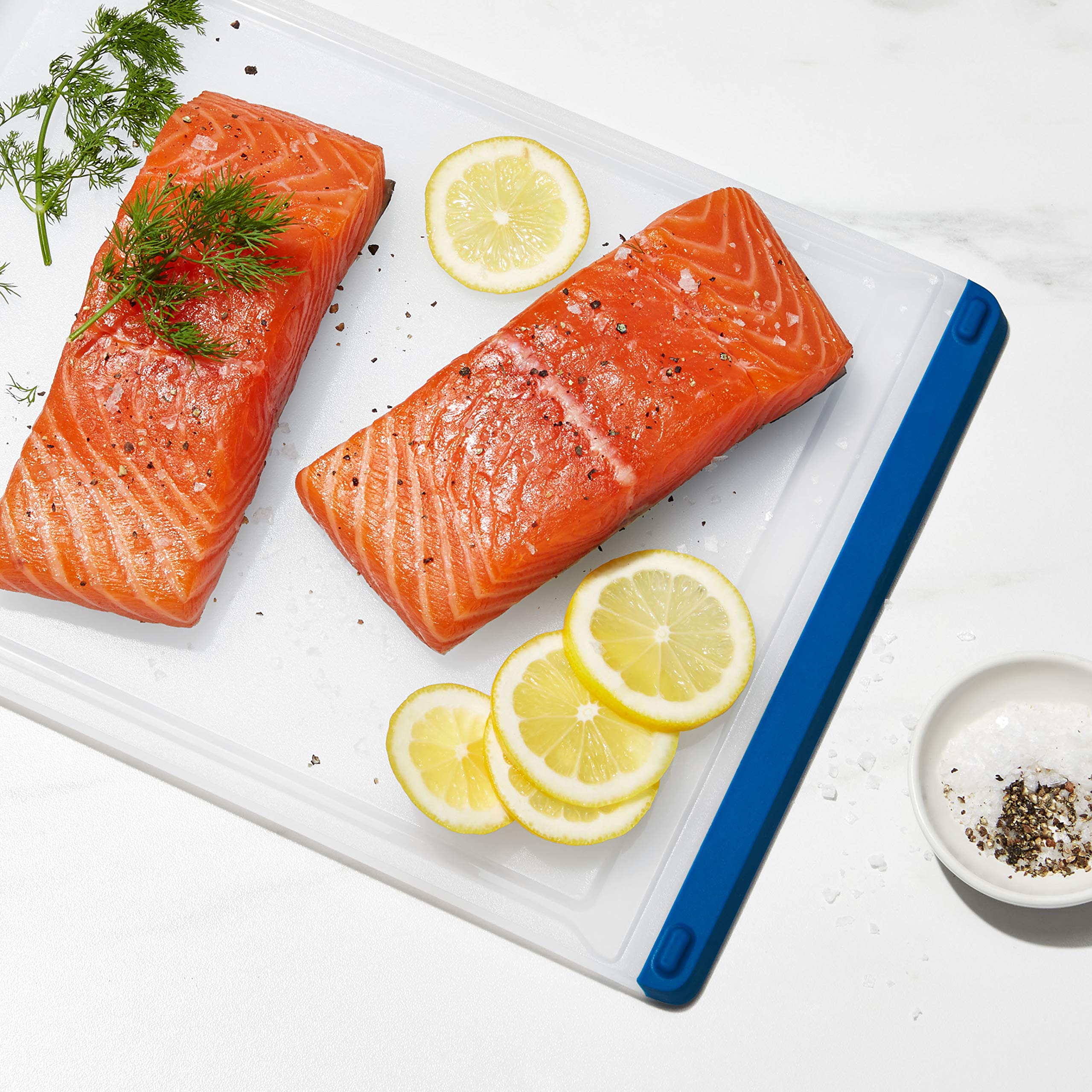 OXO Good Grips red board shown for meat prep in a busy kitchen setup.