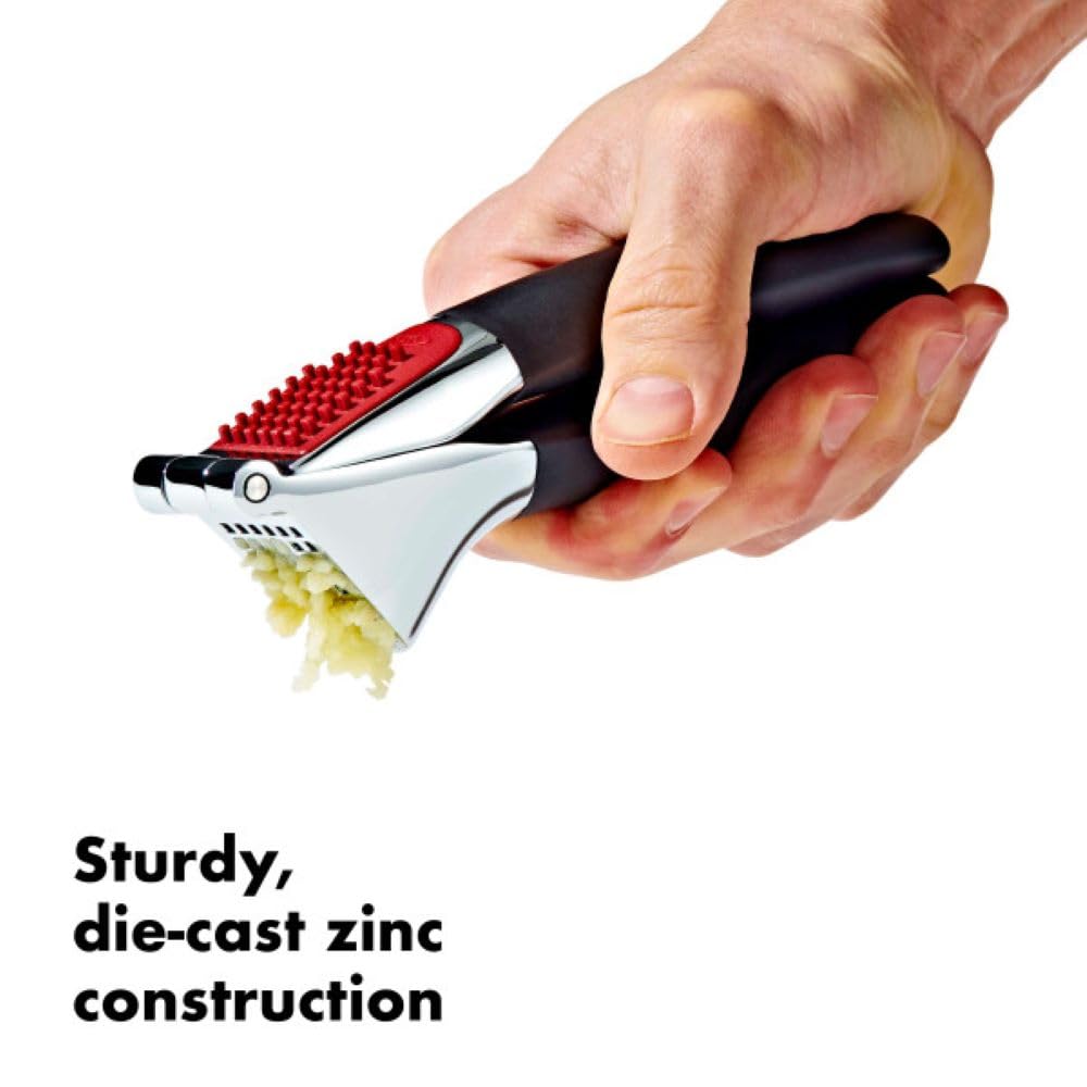 OXO garlic press large chamber fits multiple cloves for quick prep.