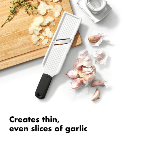OXO Good Grips garlic slicer plunger holds cloves safely from the blade.
