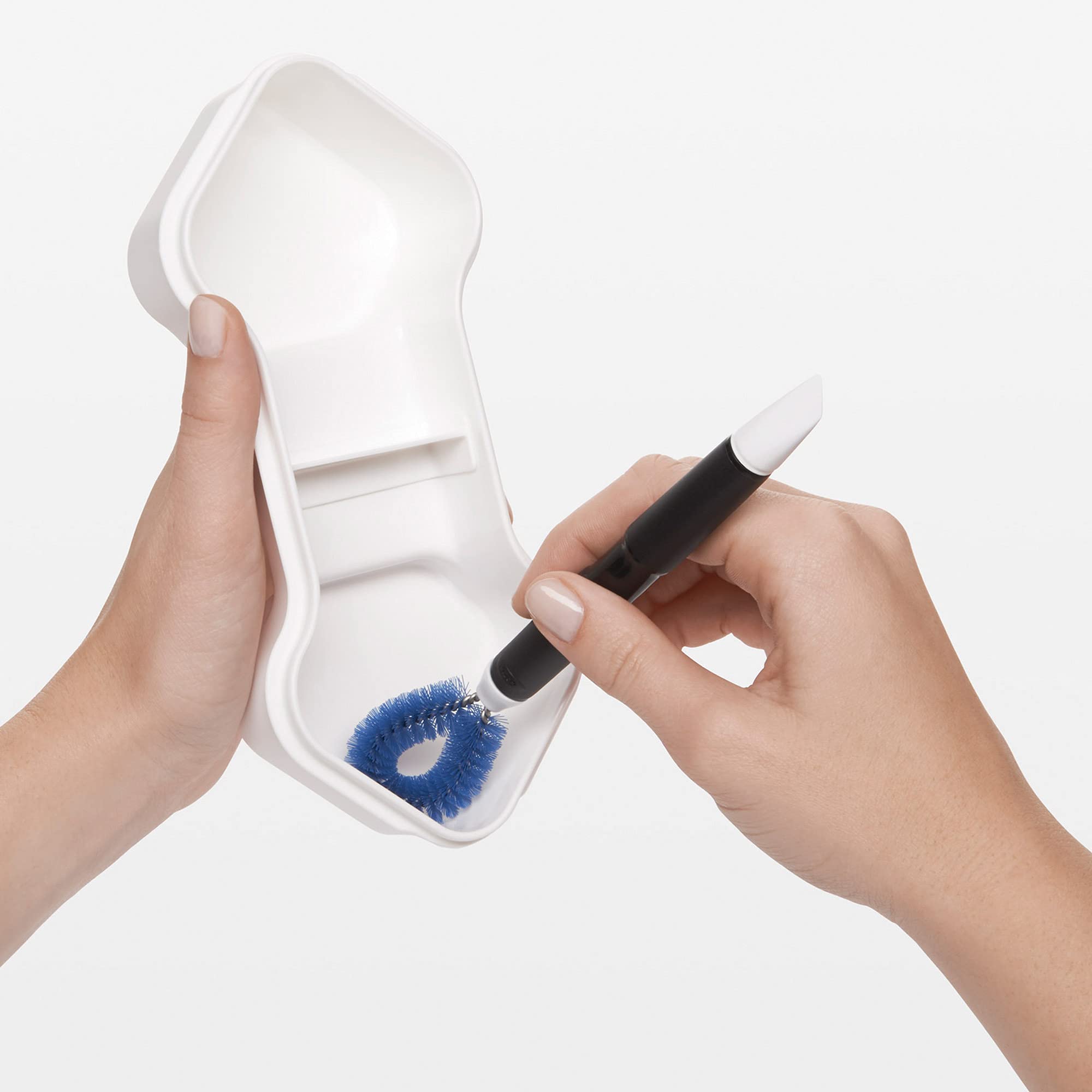 OXO Good Grips loop brush engages juicer parts for tight corner access
