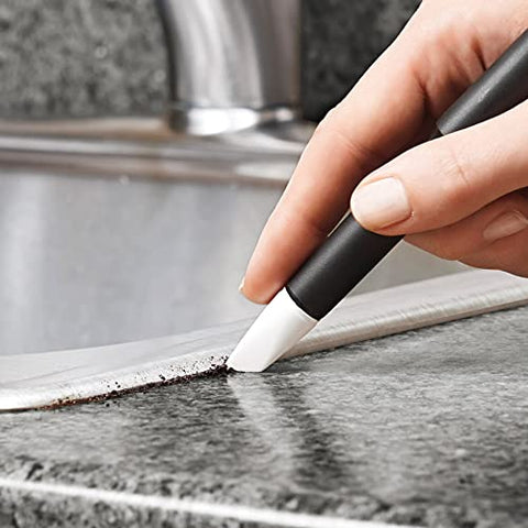 OXO Good Grips flat scraper on stovetop for baked-on messes