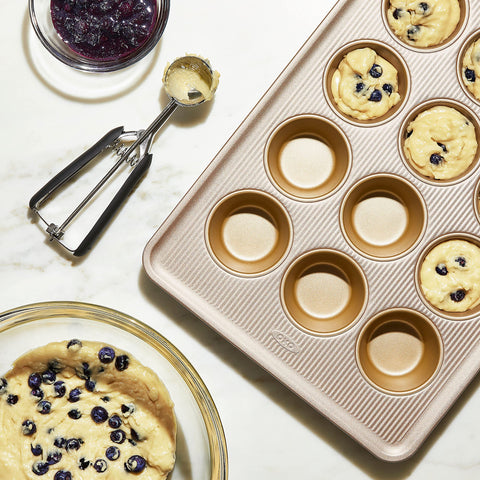 OXO Good Grips Non-Stick Pro muffin pan heavy-gauge aluminized steel for even baking.