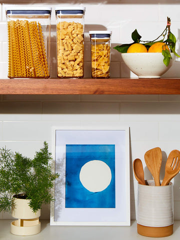 OXO Good Grips POP container push-button lid enables one-handed operation.