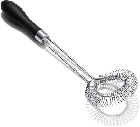 OXO Good Grips sauce and gravy whisk shows angled head for reaching pan corners.
