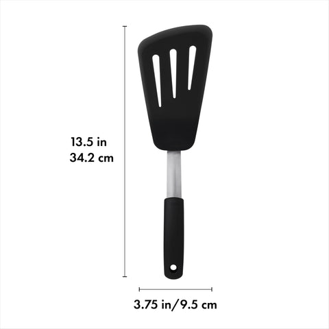 OXO Good Grips omelet turner glides beneath food in pan for intact flipping.
