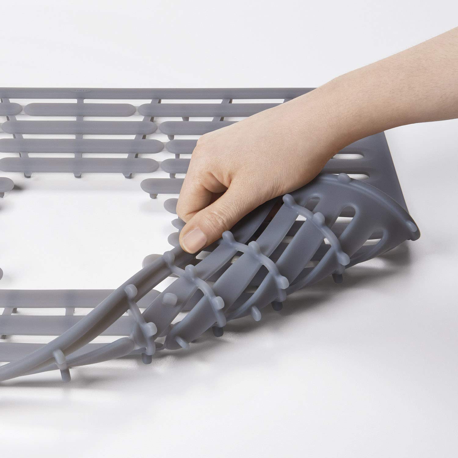 OXO Good Grips silicone sink mat with drain-hole pattern for customizable openings.