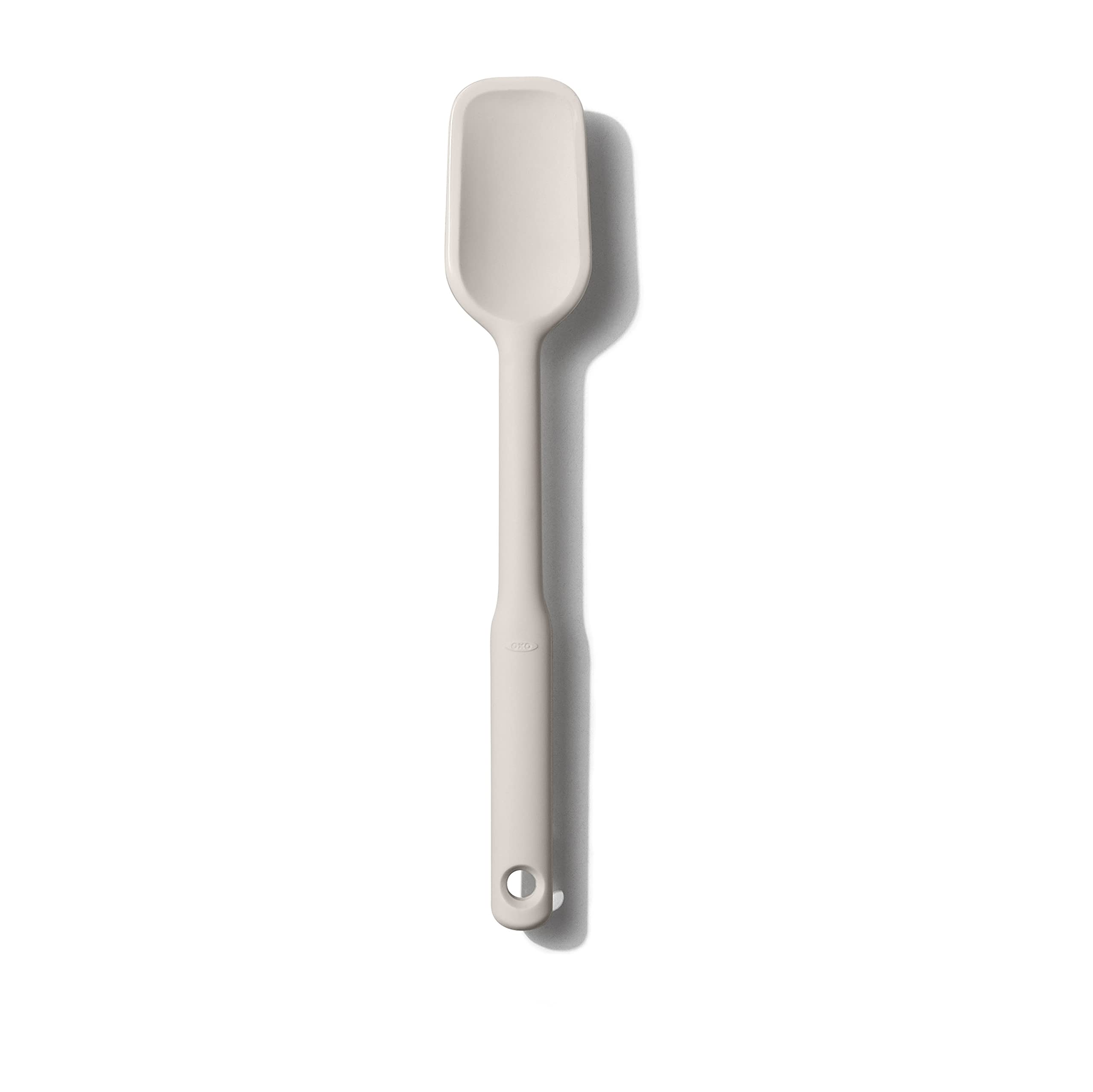 OXO Good Grips silicone spoon spatula in oat color stirring batter in a bowl