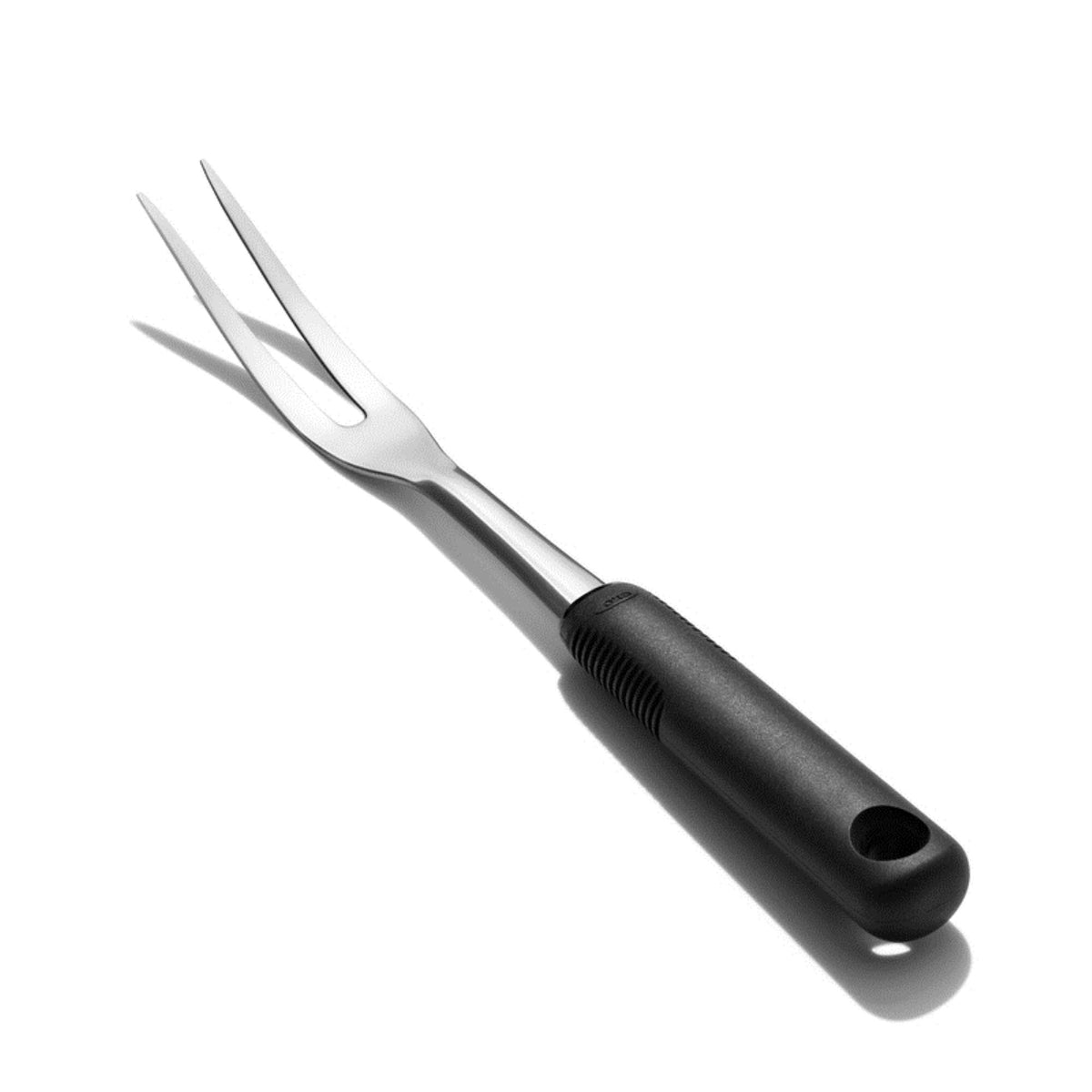 OXO Good Grips carving fork over roast for steady slicing and serving.