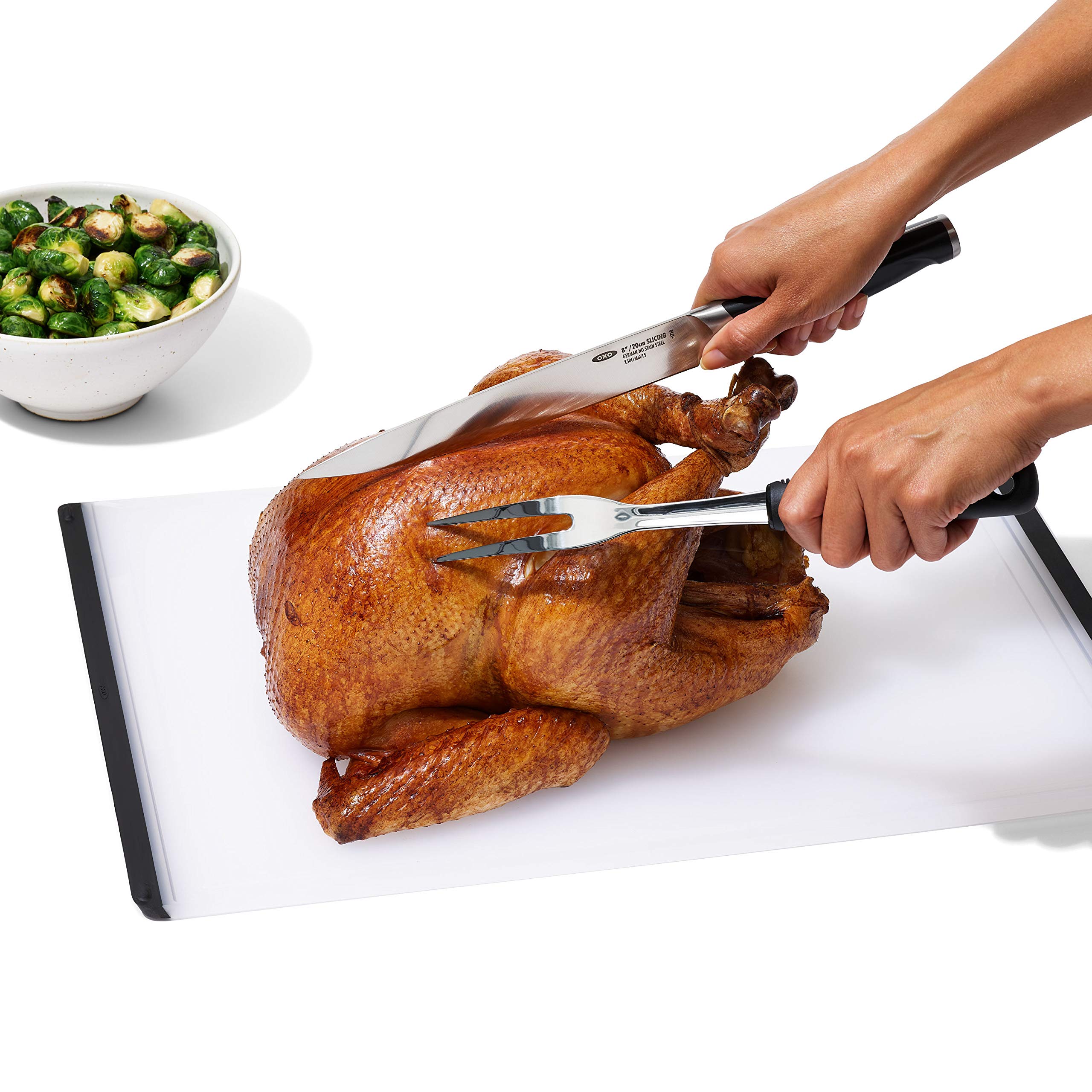 OXO Good Grips carving fork with sharp tines holding meat securely.