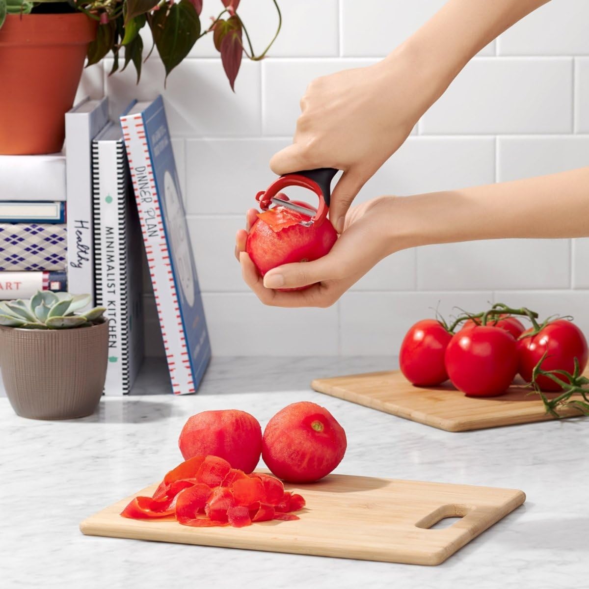 OXO Good Grips julienne peeler creating uniform carrot ribbons.