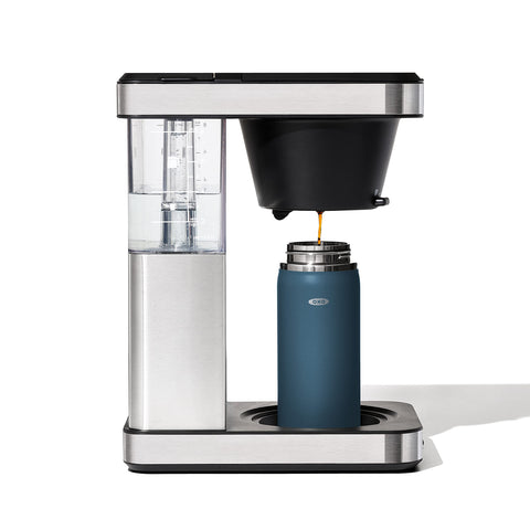 OXO Good Grips travel mug in action on the move with dark cobalt finish