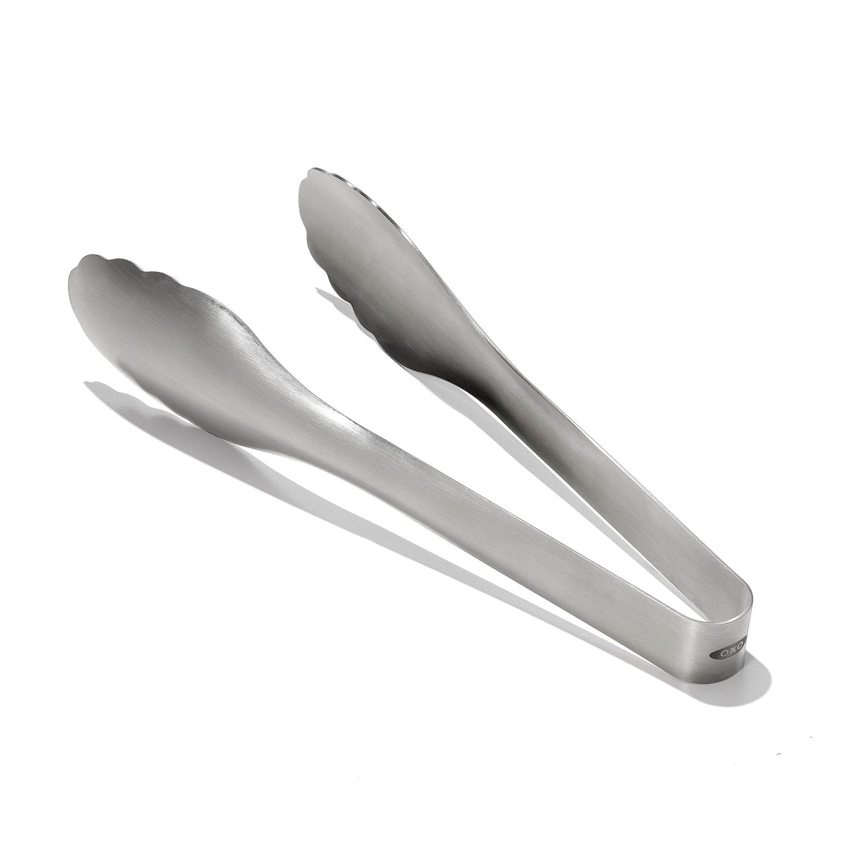 OXO Steel Serving Tongs close-up of scalloped head for added grip in tossing