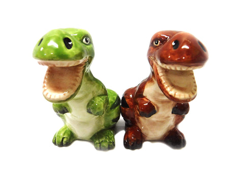 Pacific Giftware dinosaur magnetic salt and pepper shakers on kitchen countertop for convenient seasoning.