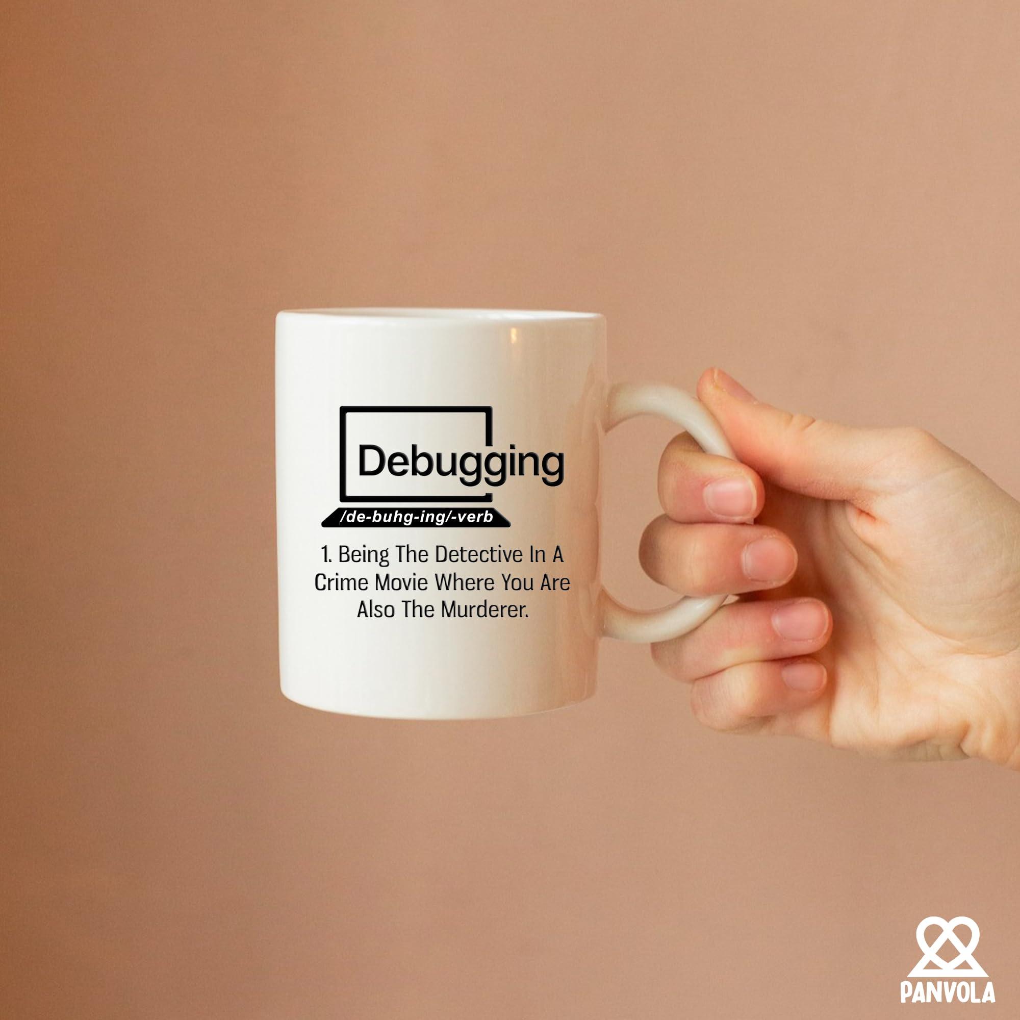 Panvola debugging mug used as a pen holder on a compact desk.