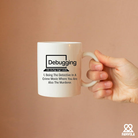 Panvola debugging mug used as a pen holder on a compact desk.