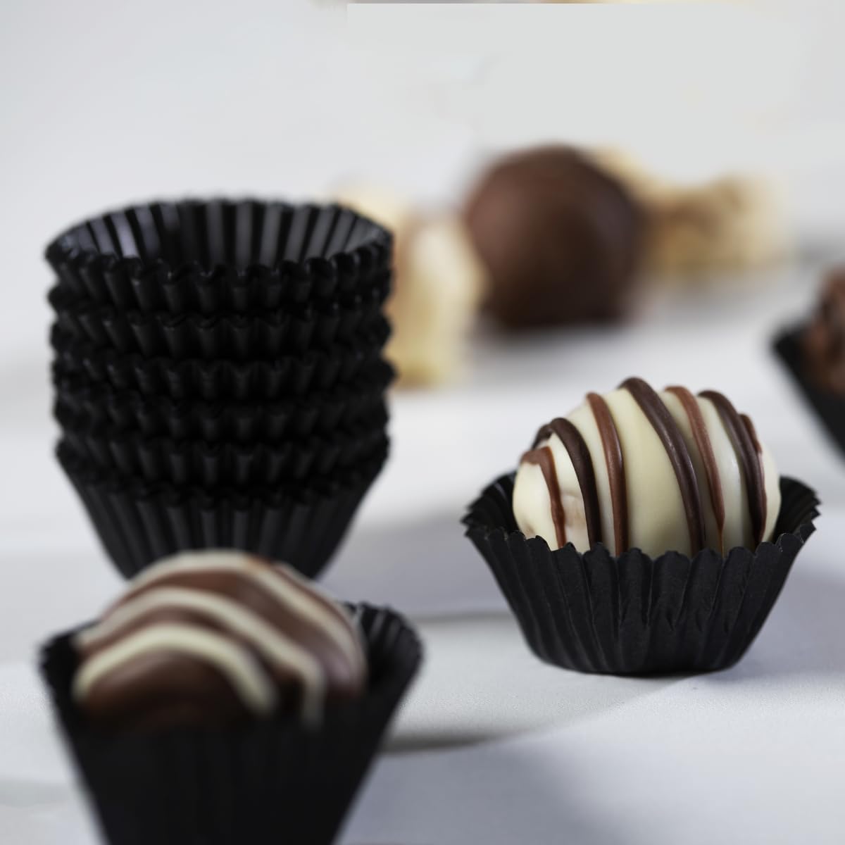 Pastry Chef's Boutique glassine black candy cups No.4 hold chocolates and truffles with a premium presentation.