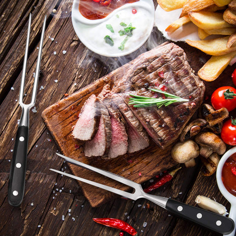 Patelai carving forks on barbecue setup for secure roasting