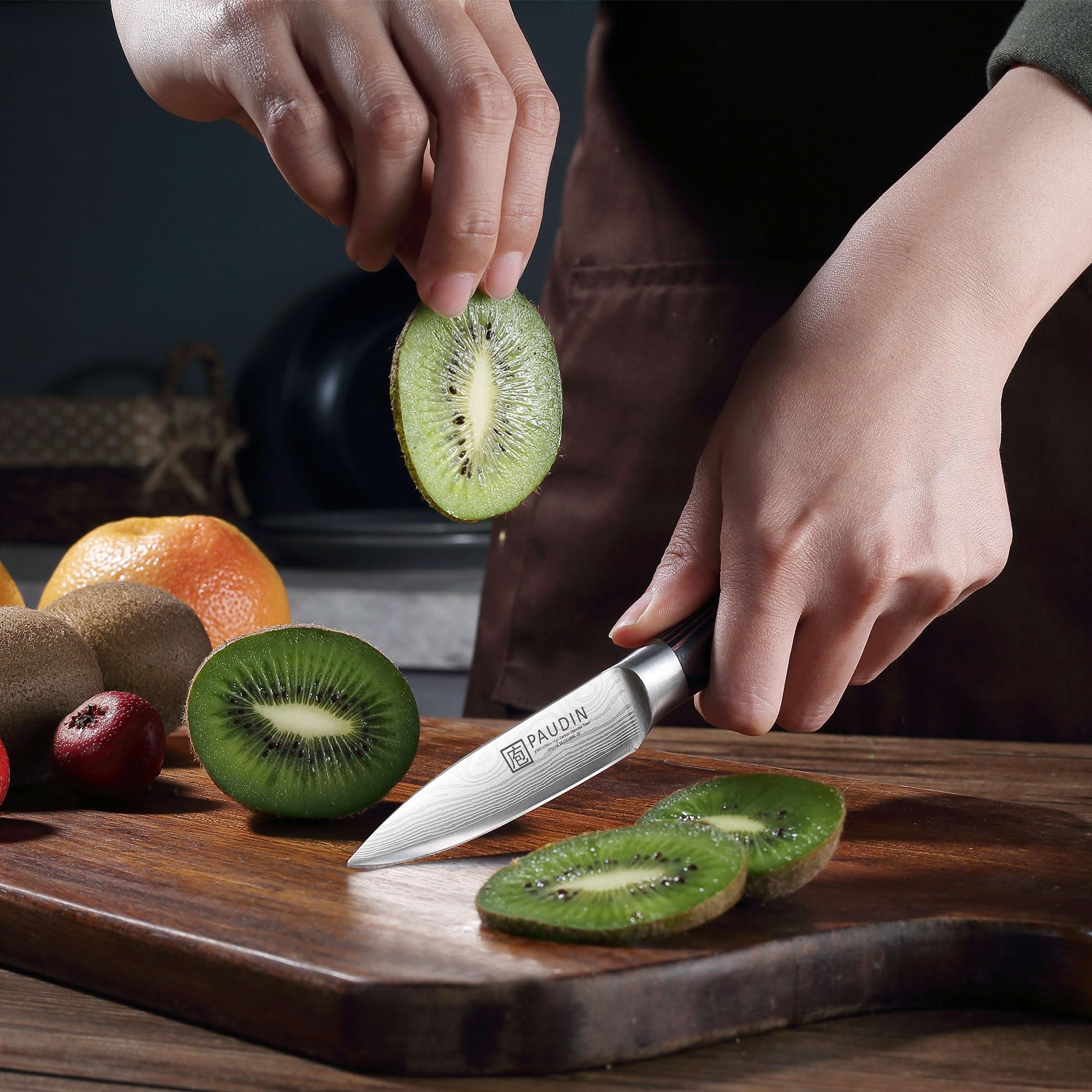 PAUDIN Paring Knife in-use image showing fruit peeling and trimming