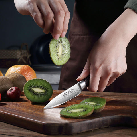 PAUDIN Paring Knife in-use image showing fruit peeling and trimming